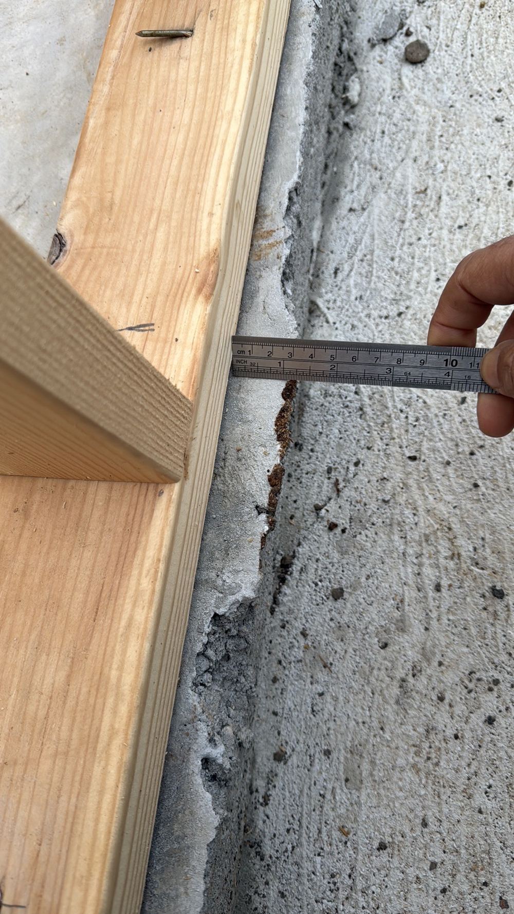 Slab edge standing more than 20mm past the frame, narrowing the brick cavity, Aintree, Deanside