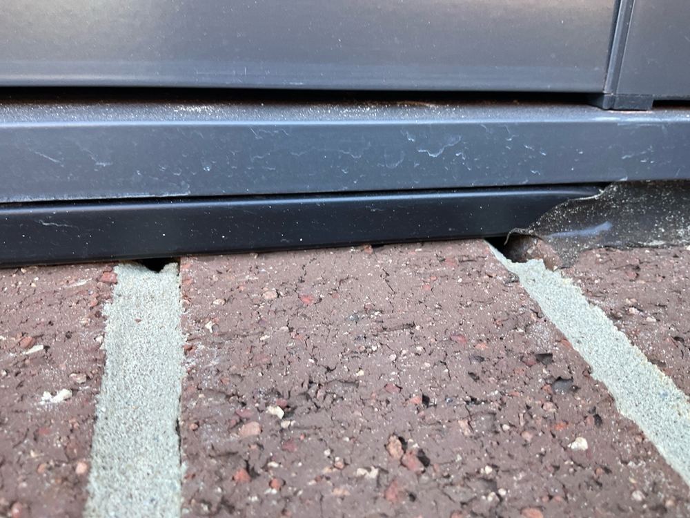 Unfilled holes in the mortar along a run of brickwork, found during a pre-handover inspection in Aintree