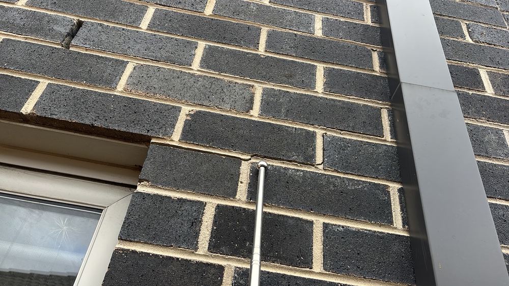 Crack through the brick veneer between 1mm and 5mm, wide enough to admit moisture, found during a pre-purchase inspection in Braybrook
